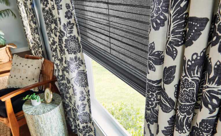 blue patterned curtains over gray blinds in living room